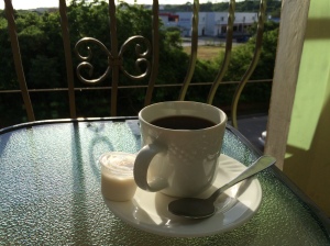 Enjoying my generously borrowed coffee and a book on the balcony.